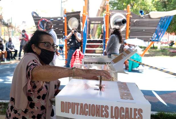 (210606) -- ECATEPEC (MEXICO), June 6, 2021 -- A woman casts her ballot during the mid-term elections at a polling station in Ecatepec, Mexico, on June 6, 2021. Mexico began midterm elections on Sunday with the opening of about 161,000 polling stations throughout the country, with about 90 million people eligible to vote to fill more than 20,000 public positions. ) MEXICO-ECATEPEC-MID-TERM ELECTIONS DavidxdexlaxPaz 