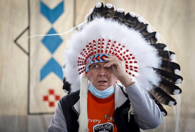 June 7, 2021, Calgary, ab, Canada: Tsuut ina Nation chief Roy Whitney adjusts his headdress before speaking after taking part in a silent march in memory of the 215 unmarked graves found at Kamloops, B.C., in Calgary, Alta., Monday, June 7, 2021. Calgary Canada - ZUMAc35_ 20210607_zaf_c35_031 Copyright: xJeffxMcintoshx