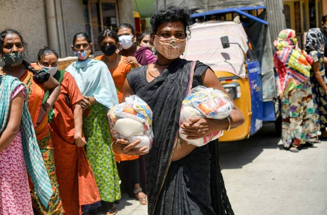 May 31, 2021, Bengaluru, Karnataka, India: A trans woman walks home with her ration supplies distributed by Yuva Bengaluru an NGO that has been distributing ration on a regular basis helping the community get through this lockdown..An Non Government Organization (NGO) known as Yuva Bengaluru Trust has come forward to help the transgender community with ration supplies during the second wave of Covid-19 lockdown. Bengaluru India - ZUMAs197 20210531_zaa_s197_335 Copyright: xMeghanaxSastryx