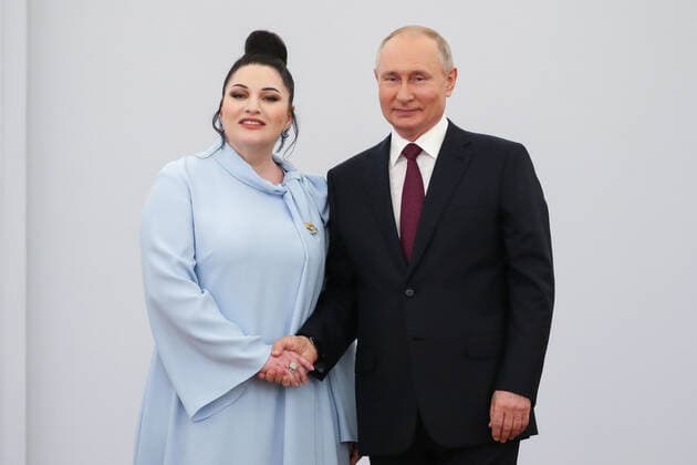 MOSCOW, RUSSIA - JUNE 12, 2021: Russia s President Vladimir Putin and Stanislavsky and Nemirovich-Danchenko Musical Theatre opera singer Hibla Gerzmava, a winner of the 2020 State Prize in literature and arts, pose during a ceremony held at the Moscow Kremlin on Russia Day to present decorations. Mikhail Klimentyev Russian Presidential Press and Information Office TASS  TS1046C9
