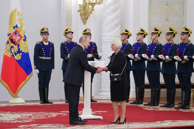 MOSCOW, RUSSIA - JUNE 12, 2021: Russia s President Vladimir Putin and Life Line Charity Foundation President Faina Zakharova (L-R front), the winner of the 2020 State Prize for charity, shake hands during a ceremony held at the Moscow Kremlin on Russia Day to present state decorations and prizes. Mikhail Klimentyev Russian Presidential Press and Information Office TASS  TS1046CE