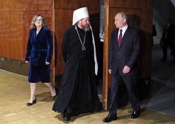MOSCOW, RUSSIA - JUNE 12, 2021: State Tretyakov Gallery Director Zelfira Tregulova, Metropolitan Tikhon of Pskov and Porkhov (Georgy Shevkunov), and Russiaâ€™s President Vladimir Putin (L-R) attend the exhibition History of Russia as seen by Artists. To the 800th Birth Anniversary of Alexander Nevsky at the State Tretyakov Gallery. The exhibition shows over 100 paintings from 37 Russian museums and three private collections. Alexander Shcherbak TASS  TS1046E8