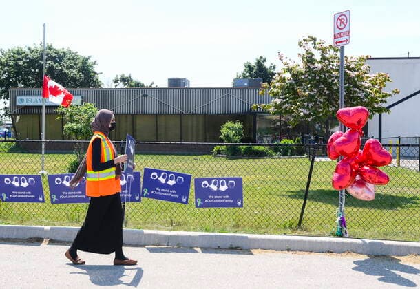 June 12, 2021, London, on, Canada: Elaaf Siddiqui, 23, places signs before the funeral service for the victims of the deadly vehicle attack on five members of the Canadian Muslim community in London, Ont., on Saturday, June 12, 2021. Four members of the family died and one is in critical but stable condition. A 20 year-old male is in custody and has been charged in what police say is a motivated hate crime. London Canada - ZUMAc35_ 20210612_zaf_c35_020 Copyright: xNathanxDenettex
