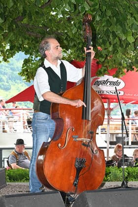 Zweiter von vier Teilen der Veranstaltung Hausmusikroas , mit heimischen Volksmusikanten, auf Plätzen des Ortes Gmunden, im oberösterreichischen Salzkammergut, im Rahmen der Salzkammergut Festwochen Gmunden 2021, am 12.06.21. Das Bild zeigt den Bassisten der Volksmusikgruppe Maschanska unter der Schillerlinde auf der Gmundner Esplanade. 2021 - Zweiter von vier Teilen der Veranstaltung Hausmusikroas , mit heimischen Volksmusikanten, auf Plätzen des Ortes Gmunden, im oberösterreichischen Salzkammergut, im Rahmen der Salzkammergut Festwochen Gmunden 2021, am 12.06.21.
