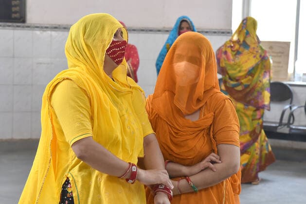 India: Women waiting in a long queue to be vaccinated Women waiting in a long queue to be covid-19 vaccinated in a special camp only for women arranged in Bikaner. Rajasthan India Copyright: DineshxGupta