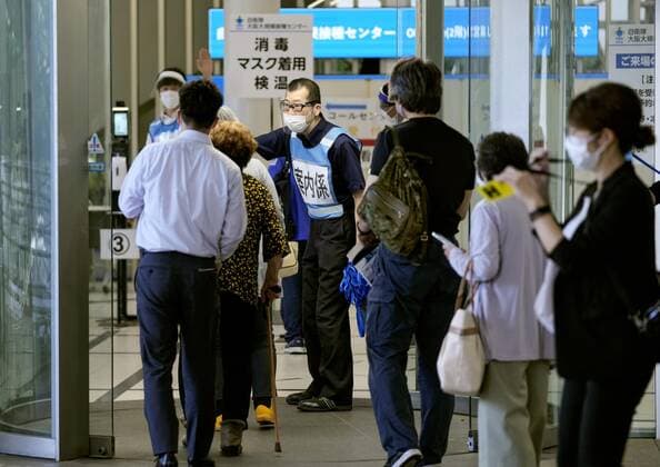 Japan s efforts to accelerate COVID-19 vaccination People enter a COVID-19 mass vaccination center in Osaka on June 14, 2021. Two state-run mass vaccination centers in Osaka and Tokyo began administering vaccines to elderly people from around Japan the same day, expanding the target areas from seven prefectures in the Tokyo and Osaka areas, as part of efforts to accelerate Japan s inoculation drive. 