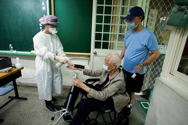 June 15, 2021, Taipei, Taiwan: A health worker disinfects an elderly man s hands..Vaccination session for elderly people over 85 years old begins on Tuesday in Taipei, Taiwan on June 15, 2021. Taipei Taiwan - ZUMAs197 20210615_zaa_s197_017 Copyright: xAnnabellexChihx