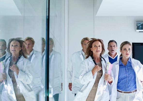 Male and female healthcare workers running in hospital model released Symbolfoto property released AJOF01336