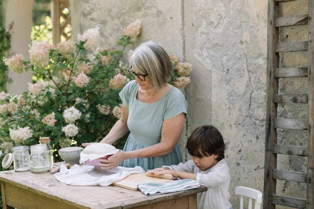 Cute boy with grandmother baking bread at back yard model released Symbolfoto property released ALBF01610