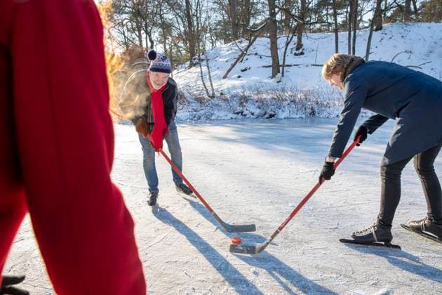 IMAGO Creative, Winter, Winterspaß, Eishockey #2 Senior man playing ice hockey with friends on snow during winter model released Symbolfoto FVDF00120