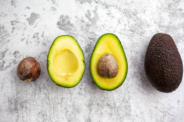Studio shot of seed, halves and whole avocado GIOF12523