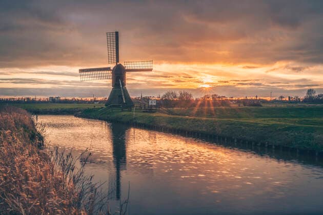 Germany, Schleswig-Holstein, Steinburg, historical Schopfmuhle Honigfleth windmill at moody sunset KEBF01873