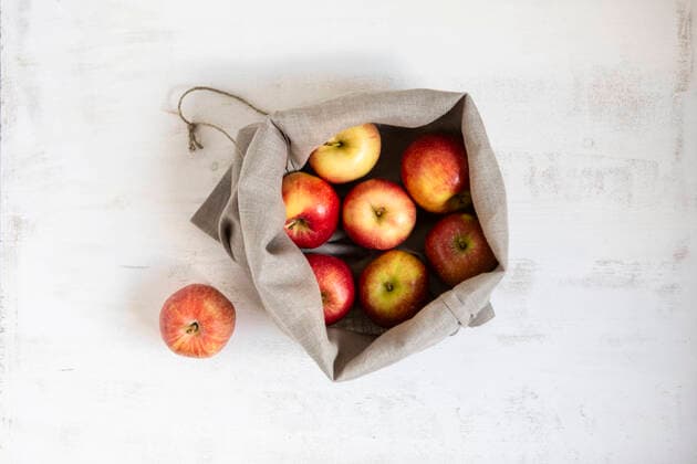 Apples collected in sack on white textured background OJF00457