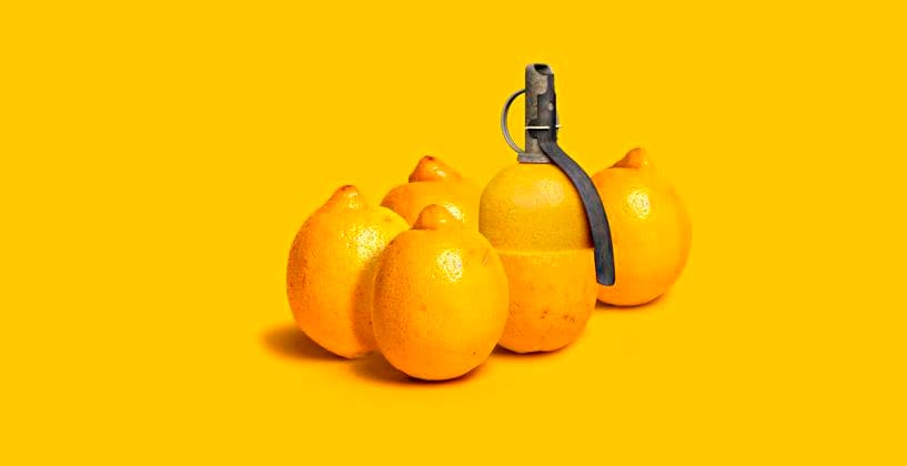 Lemons and grenade against yellow background VTF00636