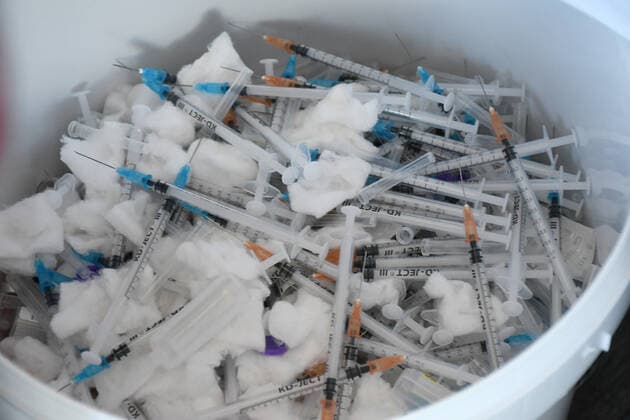 Croatia Coronavirus vaccine bus Used vaccination syringes lie in a waste bin at Coronavirus vaccine bus in Bjelovar, Croatia on June 17, 2021. Coronavirus vaccine bus travelling around city of Bjelovar and suburbs offering a walk-in vaccine service. DamirxSpehar PIXSELL