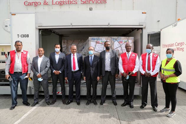 (210619) -- ADDIS ABABA, June 19, 2021 -- Representatives from Chinese side and Ethiopian side pose for a group photo with the COVID-19 vaccines donated by Chinese Red Cross Society in the background in Addis Ababa, Ethiopia, June 19, 2021. A batch of China s Sinopharm COVID-19 vaccines, donated by the Chinese Red Cross Society to its Ethiopian counterpart, arrived here on Saturday. TO GO WITH Roundup: Ethiopian Red Cross Society receives Sinopharm vaccines from Chinese counterpart ) ETHIOPIA-CHINA-RED CROSS SOCIETY-COVID-19 VACCINE-HANDOVER WangxPing 