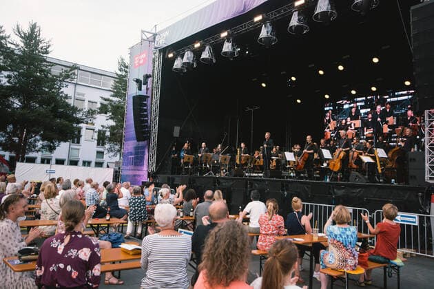 (210620) -- BONN, June 20, 2021 -- People enjoy an open-air concert performed by the Beethoven Orchestra Bonn in Bonn, Germany, on June 19, 2021. Some cultural events started to be held in Germany due to the relaxation of the anti-virus restrictions. (Photo by Xinhua) GERMANY-BONN-CONCERT-RESTRICTIONS-RELAXATION TangxYing 