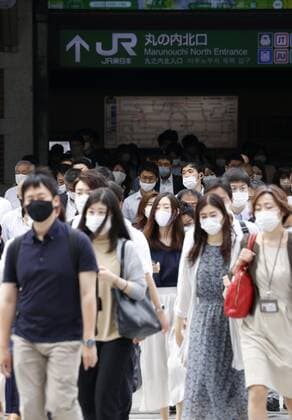 Scene in Tokyo after COVID-19 state of emergency People wearing face masks walk in front of JR Tokyo Station in the Japanese capital on June 21, 2021, during the first morning after Japan ended the COVID-19 state of emergency in Tokyo and eight other prefectures. Tokyo shifted to a quasi-state of emergency until July 11 amid concern about a rebound in infections. 