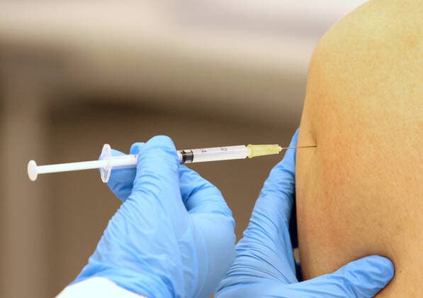 June 21, 2021, Tokyo, Japan - A student of the Nippon Sport Science University receives a dose of COVID-19 vaccine at the university s campus in Tokyo on Monday, June 21, 2021. Japan started mass vaccinations of Moderna s COVID-19 vaccines at workplaces and universities from June 21.  (162940459)