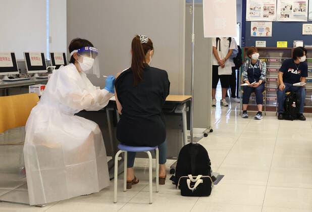 June 21, 2021, Tokyo, Japan - A student of the Nippon Sport Science University receives a dose of COVID-19 vaccine at the university s campus in Tokyo on Monday, June 21, 2021. Japan started mass vaccinations of Moderna s COVID-19 vaccines at workplaces and universities from June 21.  (162940462)