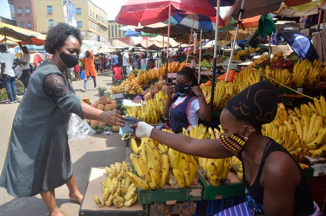 (210620) -- KAMPALA, June 20, 2021 -- A woman distributes face masks to a vendor at a market in Kampala, Uganda, on June 20, 2021. Ugandan President Yoweri Museveni on Friday announced a string of measures aimed at containing the rapid spread of the novel coronavirus as the country is experiencing a second wave. (Photo by Xinhua) UGANDA-KAMPALA-MARKET-COVID-19-MEASURES NicholasxKajoba 