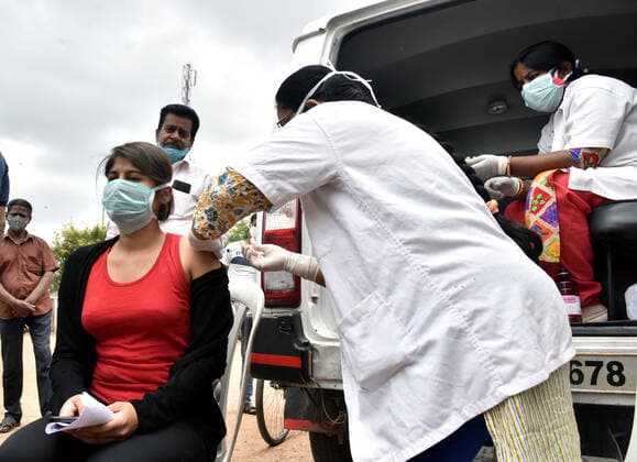 (210624) -- HYDERABAD, June 24, 2021 -- A health worker administers a dose of COVID-19 vaccine to a woman in Hyderabad, India, on June 24, 2021. (Str Xinhua) INDIA-HYDERABAD-COVID-19 VACCINATION PxArthaSarkartonglian 