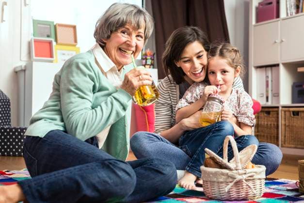 Multi-generation family playing picnic in nursery model released Symbolfoto property released AUF00634