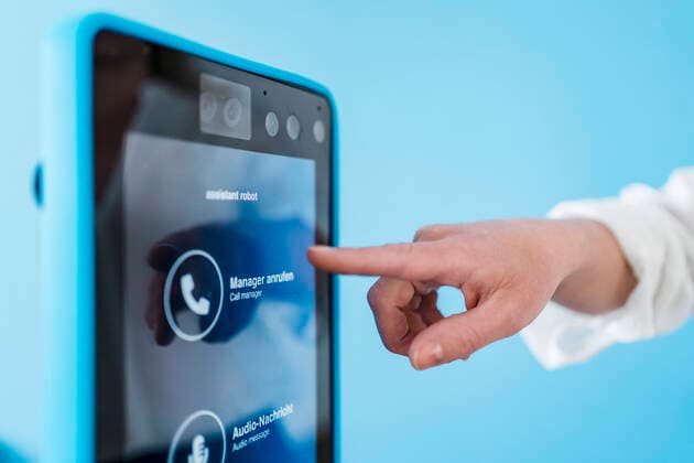Businesswoman touching robotic assistant in office model released Symbolfoto property released DIGF15739