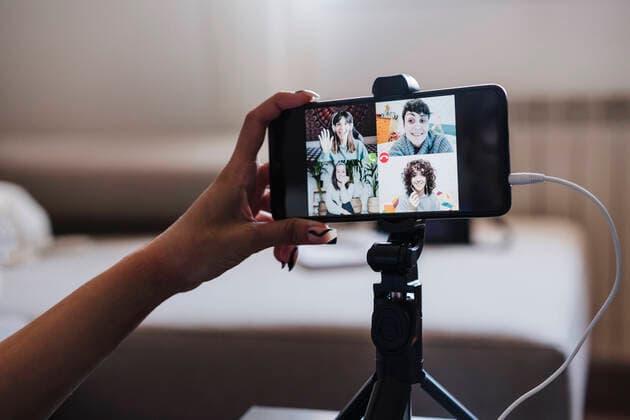 Woman video conferencing on smart phone at home model released Symbolfoto property released EBBF03868