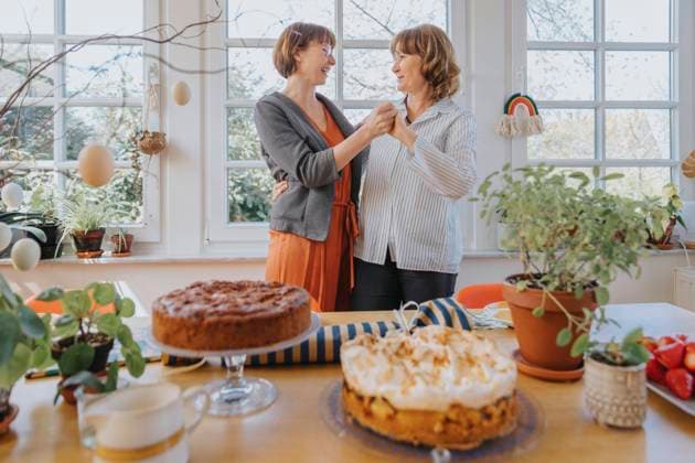Mother and daughter holding hands while dancing in dining room during Easter model released Symbolfoto property released MFF07991