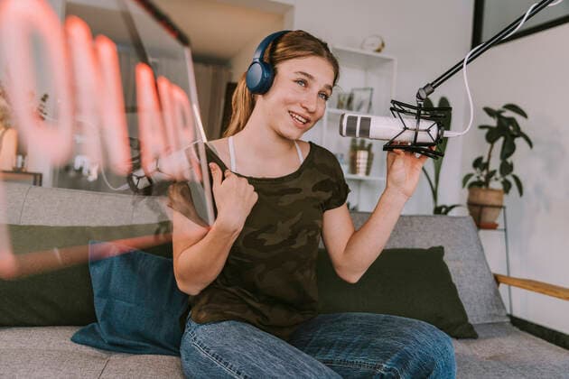 Teenage girl speaking on microphone while broadcasting at home model released Symbolfoto property released MFF08132