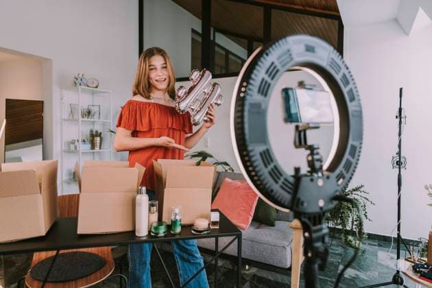 Teenage girl holding hashtag sign and filming at home model released Symbolfoto property released MFF08168