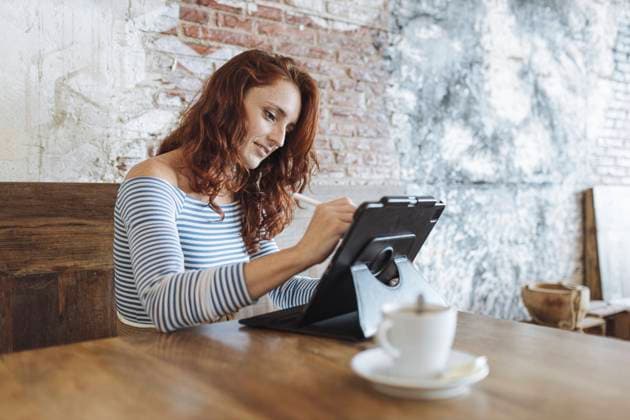 Female graphic designer using tablet while sitting at cafe model released Symbolfoto property released MTBF01024