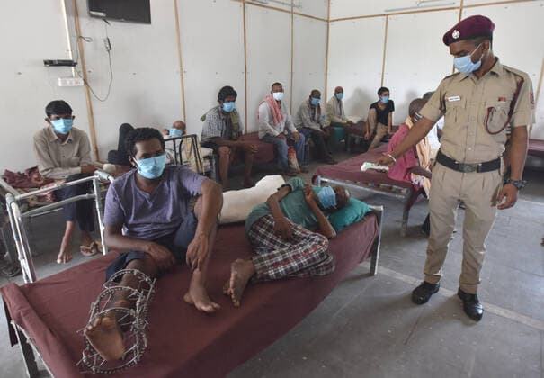 NEW DELHI, INDIA - JUNE 25: A DCD worker thermal scanning a Homeless man before a shot of Covid vaccine during the First Vaccination camp for homeless is starting at Yamuna Pushta Night Shelter near Nigam Bodh Ghat opposite Hanuman Mandir on June 25, 2021 in New Delhi, India. (Photo by Sonu Mehta Hindustan Times) Covid Vaccination Camp For Homeless