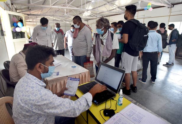 NEW DELHI, INDIA - JUNE 25: Homeless people Lineup for registration for a shot of Covid vaccine during the First Vaccination camp for homeless is starting at Yamuna Pushta Night Shelter near Nigam Bodh Ghat opposite Hanuman Mandir on June 25, 2021 in New Delhi, India. (Photo by Sonu Mehta Hindustan Times) Covid Vaccination Camp For Homeless