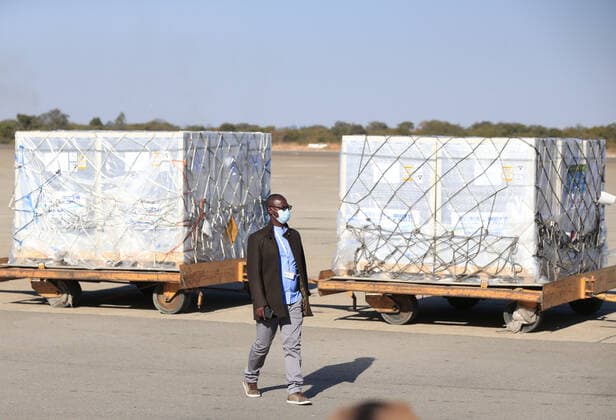 (210626) -- HARARE, June 26, 2021 -- A man walks past the COVID-19 vaccine from China at R.G. Mugabe International Airport in Harare, Zimbabwe, on June 26, 2021. Zimbabwe on Saturday received a shipment of Sinopharm COVID-19 vaccine doses from China as the southern African country ramps up inoculations to battle the third wave of the coronavirus pandemic. (Photo by Xinhua) ZIMBABWE-HARARE-CHINA-COVID-19 VACCINE-ARRIVAL ShaunxJusa 