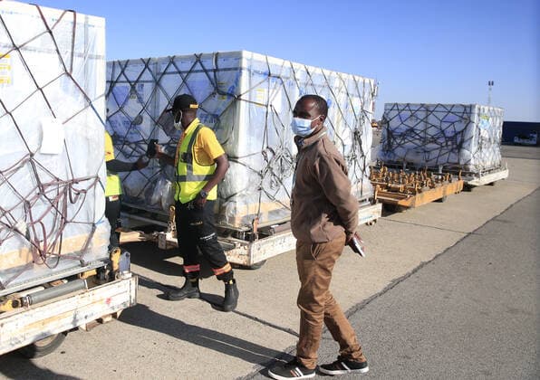 (210626) -- HARARE, June 26, 2021 -- Workers prepare to transfer the COVID-19 vaccine from China at R.G. Mugabe International Airport in Harare, Zimbabwe, on June 26, 2021. Zimbabwe on Saturday received a shipment of Sinopharm COVID-19 vaccine doses from China as the southern African country ramps up inoculations to battle the third wave of the coronavirus pandemic. (Photo by Xinhua) ZIMBABWE-HARARE-CHINA-COVID-19 VACCINE-ARRIVAL ShaunxJusa 