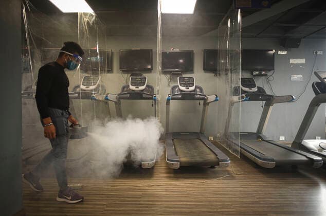 NEW DELHI, INDIA JUNE 27: A worker chemically disinfects the premises at Anytime Fitness Gym ahead of its reopening tomorrow following the Delhi government?s nod, at Malviya Nagar, on June 27, 2021 in New Delhi, India. Gyms and yoga centres have been allowed to reopen in Delhi from Monday at 50% capacity, an official government order said. Banquet halls, marriage halls, and hotels have also been permitted to host weddings, but the number of guests has been capped at 50, the order said. (Photo by Sanchit Khanna Hindustan Times ) Delhi Unlock 5: Gyms, Banquet Halls, Hotels To Open From Monday