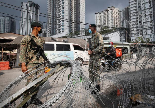 June 27, 2021, Kuala Lumpur, Malaysia: Malaysian soldiers stand guard near the barbwire at the Segambut Dalam housing area which was placed under the enhanced movement control order (EMCO) due to surge in the number of COVID-19 daily cases recorded..Malaysia government announced the one month full lockdown which is due on Monday will be extended due to the daily high number of coronavirus infections cases reported. Kuala Lumpur Malaysia - ZUMAs197 20210627_zaa_s197_078 Copyright: xWongxFokxLoyx