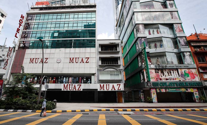 June 27, 2021, Kuala Lumpur, Malaysia: A woman crosses the road along an empty street in downtown Kuala Lumpur..Malaysia government announced the one month full lockdown which is due on Monday will be extended due to the daily high number of coronavirus infections cases reported. Kuala Lumpur Malaysia - ZUMAs197 20210627_zaa_s197_082 Copyright: xWongxFokxLoyx