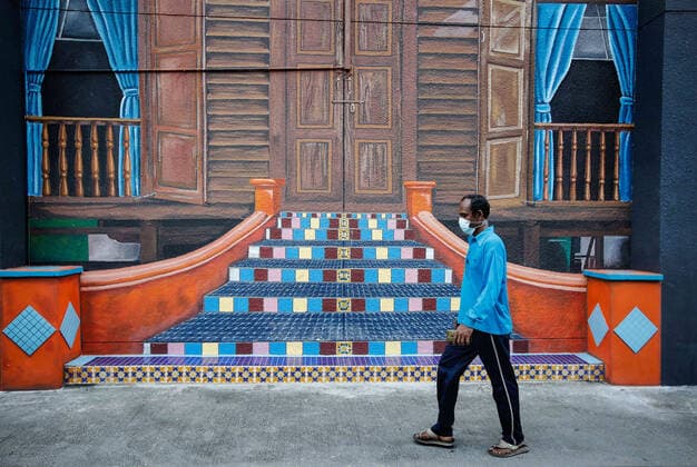 June 27, 2021, Kuala Lumpur, Malaysia: A man wearing a face mask as a precaution against the spread of coronavirus (COVID-19) walks past a mural in downtown Kuala Lumpur..Malaysia government announced the one month full lockdown which is due on Monday will be extended due to the daily high number of coronavirus infections cases reported. Kuala Lumpur Malaysia - ZUMAs197 20210627_zaa_s197_068 Copyright: xWongxFokxLoyx