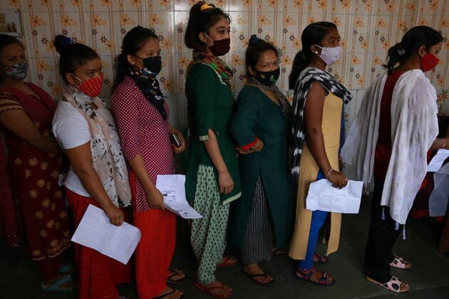 India: Vaccination for sex workers Sex Workers wait in line to get inoculated with the COVID 19 vaccine against the Covid-19 coronavirus, at a vaccination centre Red Light Area in Kolkata on June 28,2021. State Goverment Health Department and Kolkata Municipal corporation organized more than 300 Sex workers vacined today. Kolkata West Bengal India Copyright: DipaxChakraborty