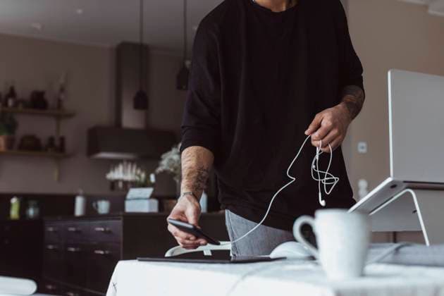 Midsection of businessman using smart phone while working at home Sweden, Gothenburg, model released, property released Copyright: xMaskotx , MA87128