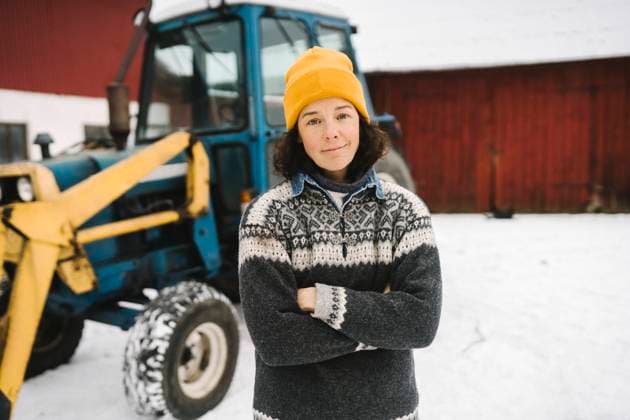 Portrait of mature woman standing with arms crossed against tractor during winter Sweden, Vastergotland, model released, property released Copyright: xMaskotx , MA87444