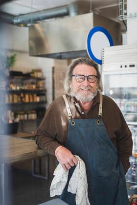 Portrait of male owner owner smiling while standing in store Sweden, Stockholm, model released, property released Copyright: xMaskotx , MA87744
