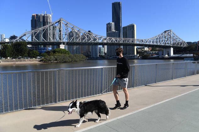 QLD CORONAVIRUS COVID19, A man wearing a protective face mask is seen walking his dog on the New Farm riverwalk, beside the Brisbane River in Brisbane, Tuesday, June 29, 2021. People in Brisbane have been instructed to wear protective face masks as authorities try to suppress a growing coronavirus (COVID-19) cluster. ( NO ARCHIVING, EDITORIAL USE ONLY, NO USE IN BOOKS WITHOUT CONSENT BRISBANE QLD AUSTRALIA  Copyright: xDARRENxENGLANDx 20210629001553387850