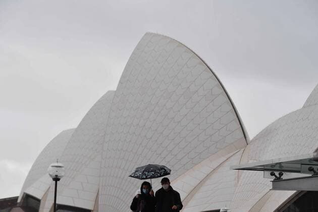 NSW CORONAVIRUS COVID19, A couple wearing masks, walk past the Sydney Opera House steps in Sydney, Tuesday, June 29, 2021. More than five million people in Greater Sydney and its surrounds have gone into a 14-day lockdown as health authorities try to regain control of a coronavirus outbreak. ( NO ARCHIVING, EDITORIAL USE ONLY, NO USE IN BOOKS WITHOUT CONSENT SYDNEY NSW AUSTRALIA  Copyright: xMICKxTSIKASx 20210629001553442796