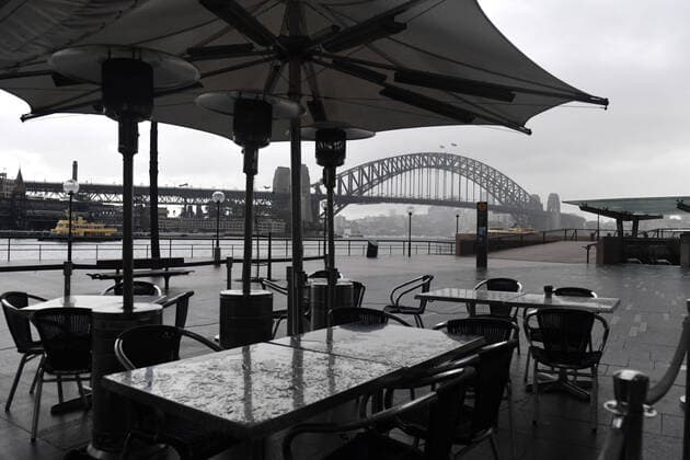 NSW CORONAVIRUS COVID19, Empty tables and chairs are seen in front of the Sydney Harbour Bridge in Sydney, Tuesday, June 29, 2021. More than five million people in Greater Sydney and its surrounds have gone into a 14-day lockdown as health authorities try to regain control of a coronavirus outbreak. ( NO ARCHIVING, EDITORIAL USE ONLY, NO USE IN BOOKS WITHOUT CONSENT SYDNEY NSW AUSTRALIA  Copyright: xMICKxTSIKASx 20210629001553443926