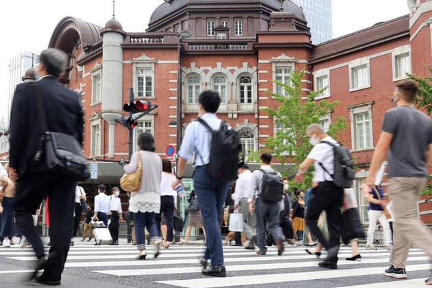 June 29, 2021, Tokyo, Japan - People cross a road in front of the Tokyo station in Tokyo on Tuesday, June 29, 2021. Japan s jobless rate in May worsened to 3.0 percent, announced by Internal Affairs Ministry on June 29, the highest level in five months amid outbreak of the new coronavirus.  (163555454)