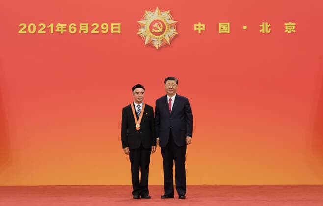 (210629) -- BEIJING, June 29, 2021 -- Chinese President Xi Jinping, also general secretary of the Communist Party of China (CPC) Central Committee and chairman of the Central Military Commission, presents the July 1 Medal, the Party s highest honor, to Memetjan Wumer at the award ceremony at the Great Hall of the People in Beijing, capital of China, June 29, 2021. The award ceremony of the July 1 Medal was held Tuesday morning at the Great Hall of the People in Beijing. ) CHINA-BEIJING-XI JINPING-JULY 1 MEDAL-AWARD CEREMONY (CN) LixXueren 